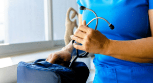doctor in blue scrubs holding stethoscope