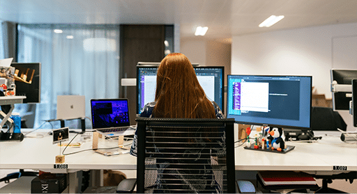 person at computer in office dealing with incident management