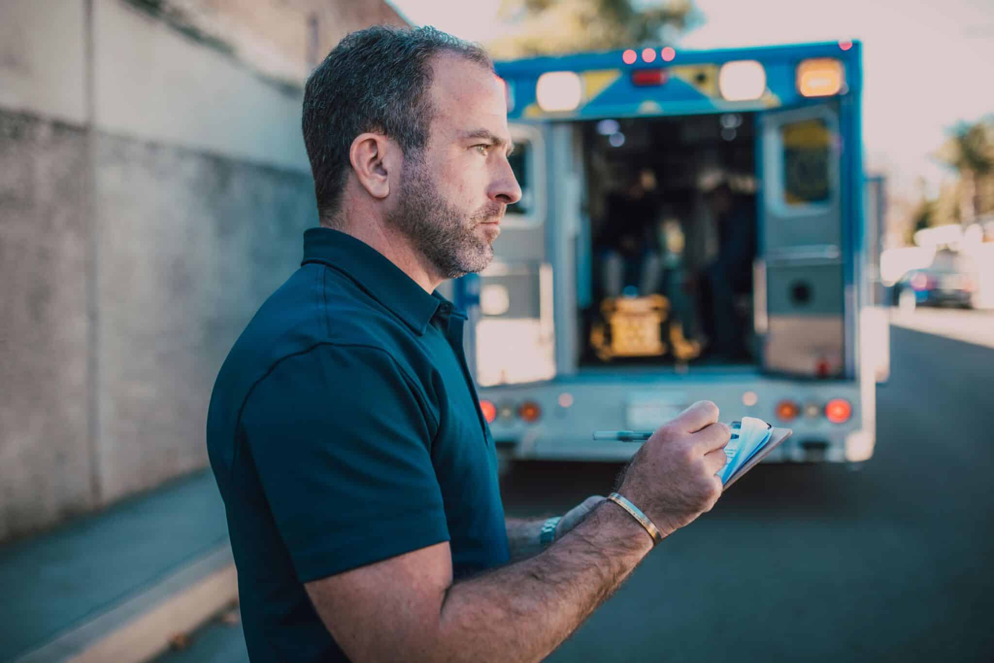 man standing by ambulance managing risk