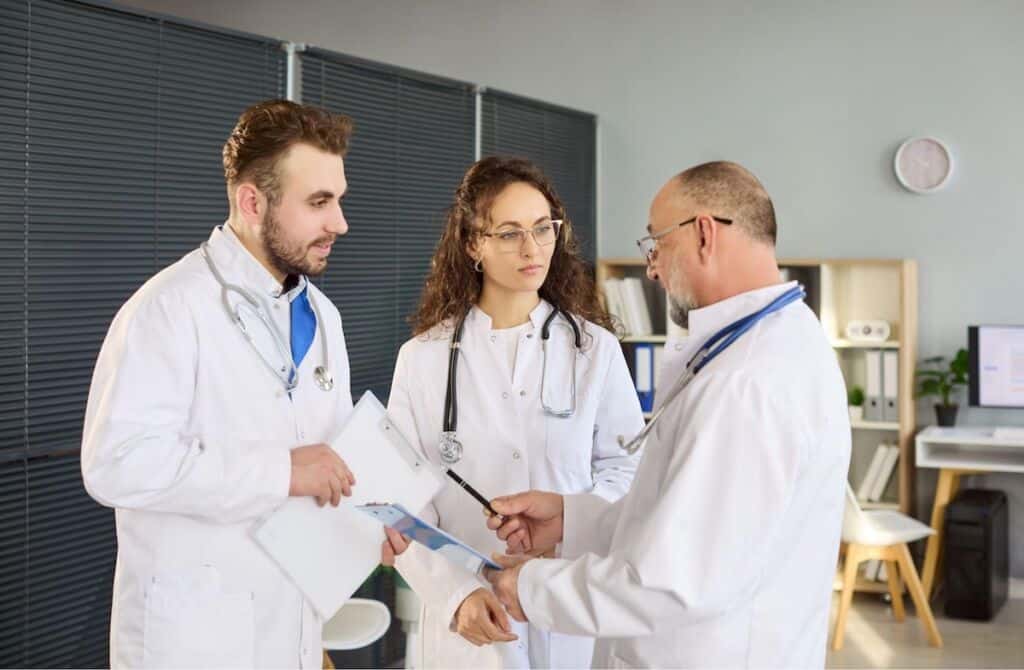 Doctors reviewing a plan together | Healthcare compliance plan template